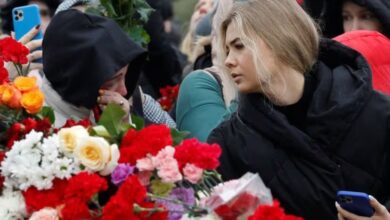 Russian mourners lower their flags, and suspects in a deadly concert hall attack are being charged